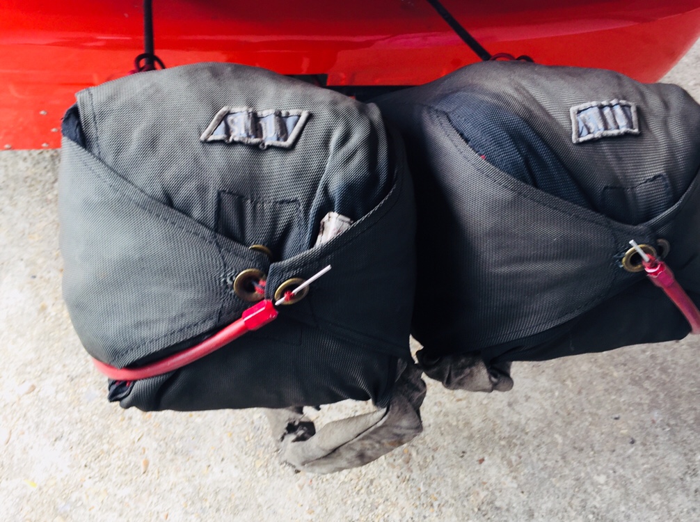 Chute bags on the back of a car. 