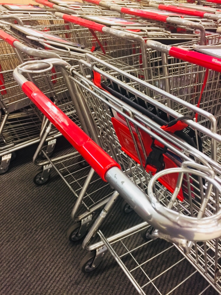 View of multiple grocery baskets with coffee holders