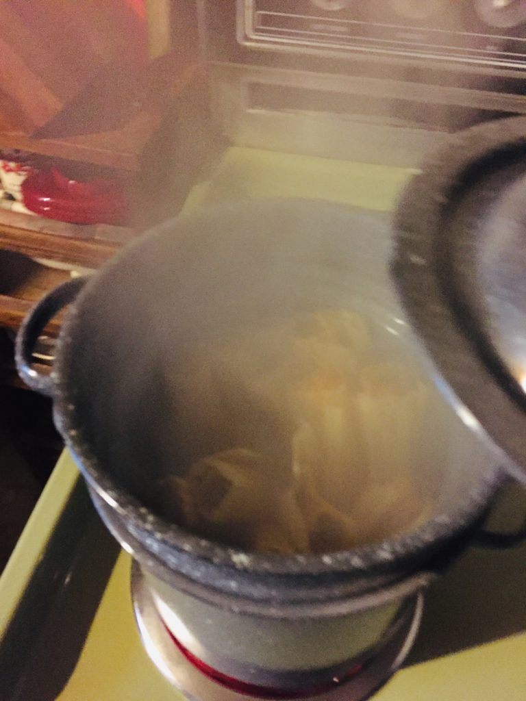 Steaming tamales in a strainer pot