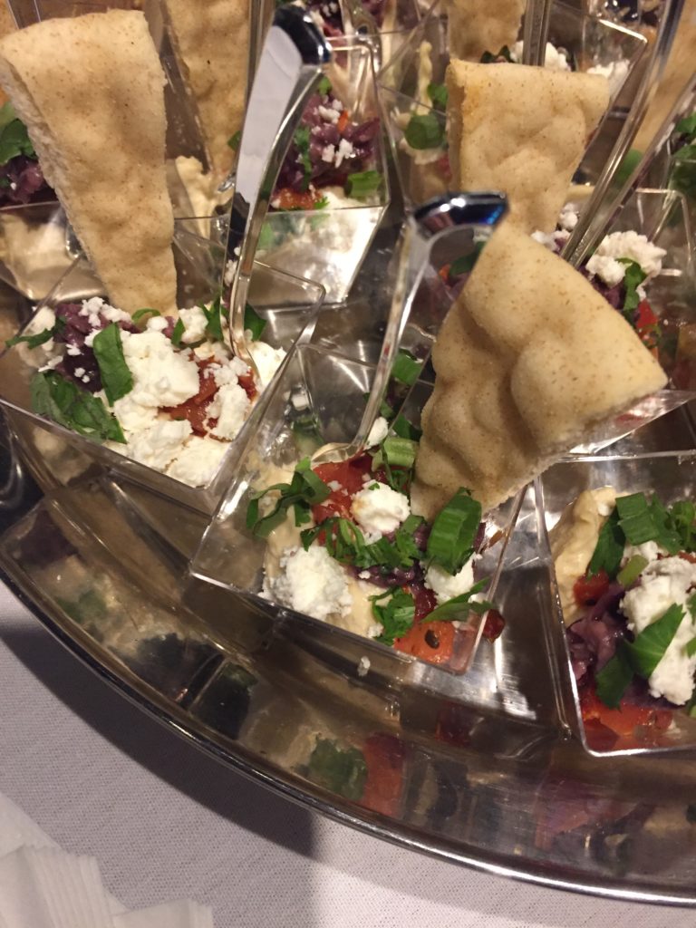 Hummus in shot glasses with pita bread triangles