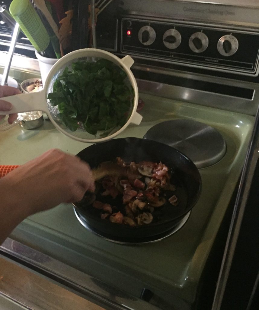 Sauteeing mushrooms with spinach added in