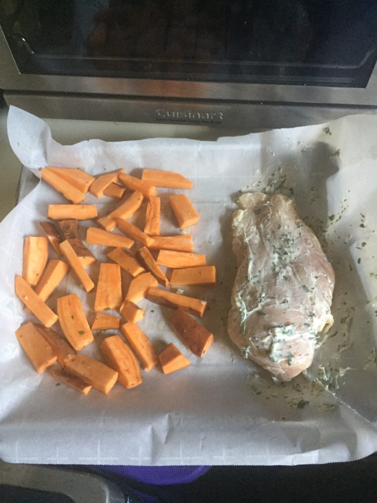 Chicken and sweet potatoes on baking sheet