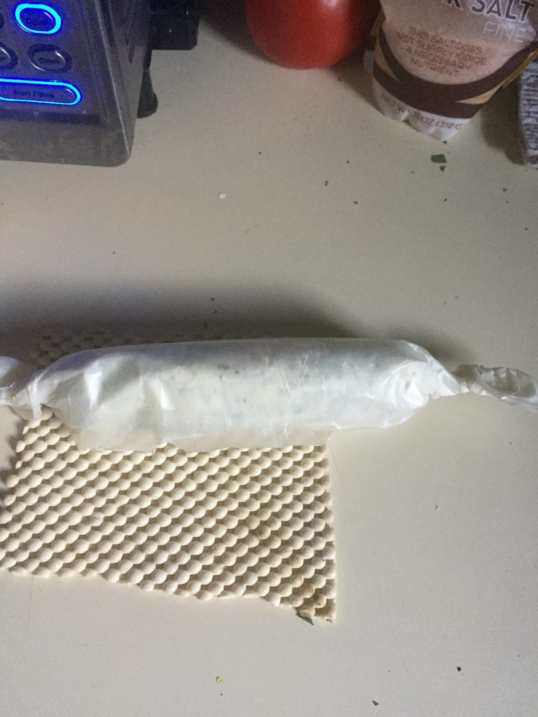 Rolled up butter in waxed paper