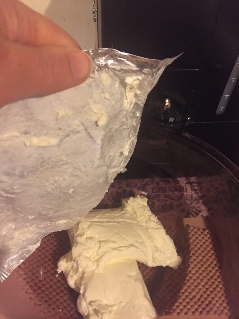 Emptying cream cheese into bowl