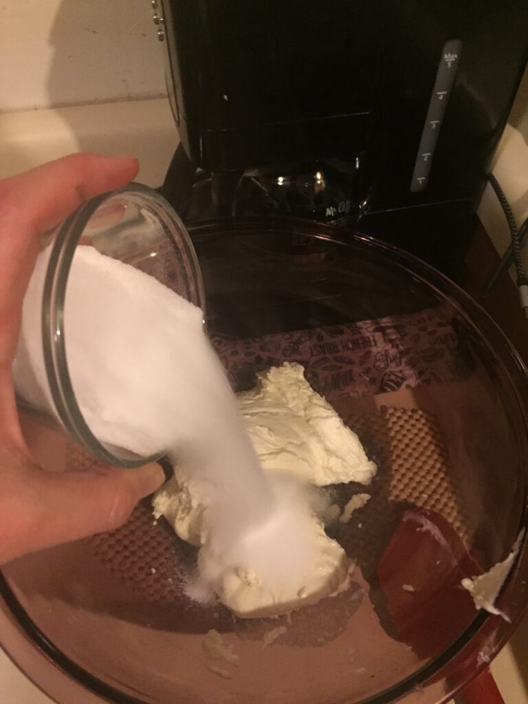 Pouring sweetener into mixing bowl