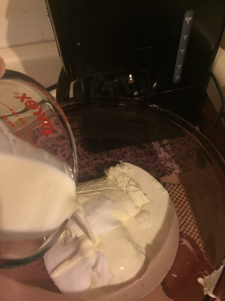 Pouring cream into mixing bowl