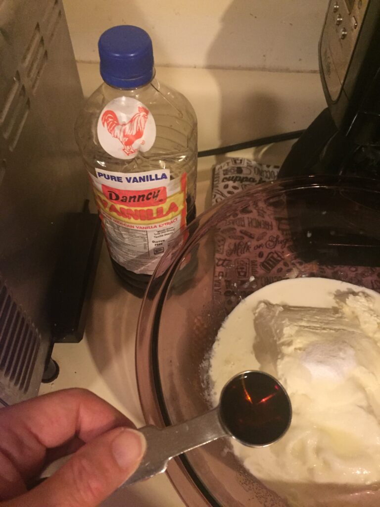 Pouring vanilla into mixing bowl