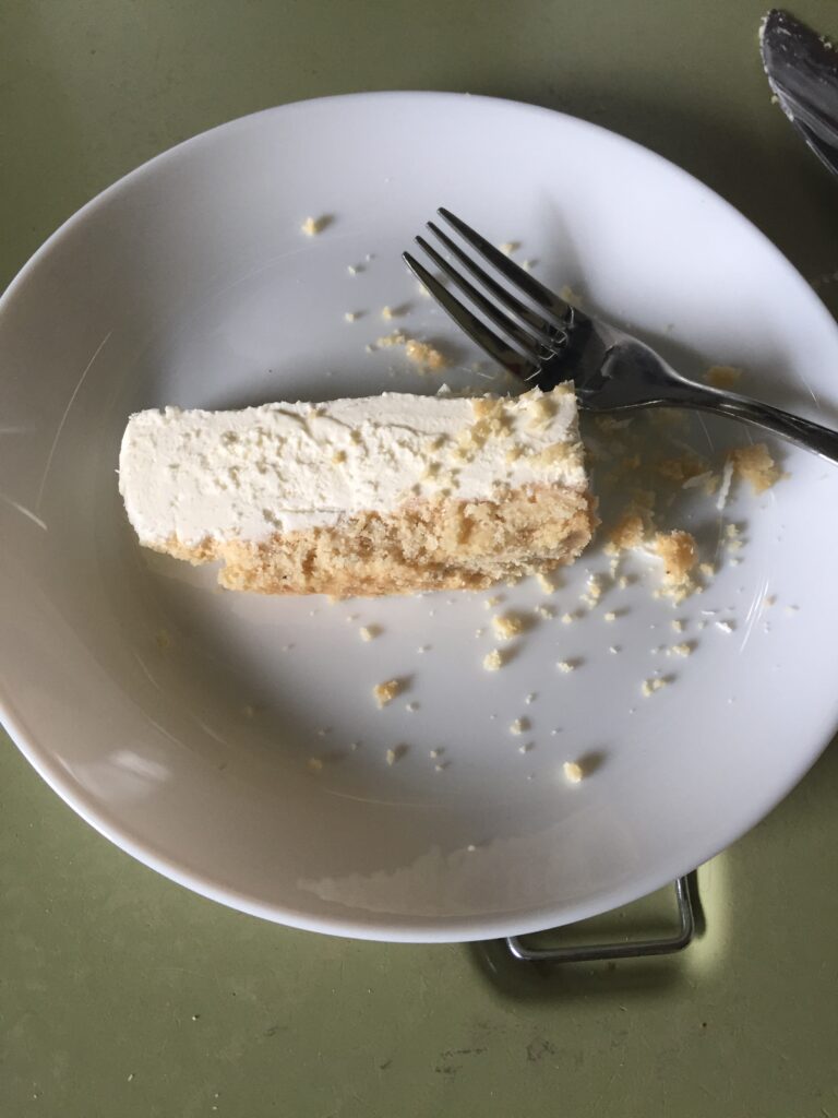 Slice of cheesecake on plate with fork