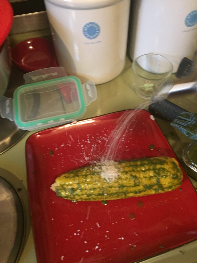 Shaking salt onto corn