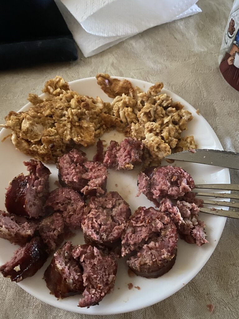 Eggs and deer sausage on a plate