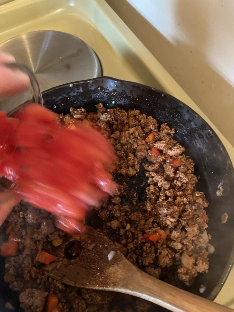 Adding tomatoes into pot