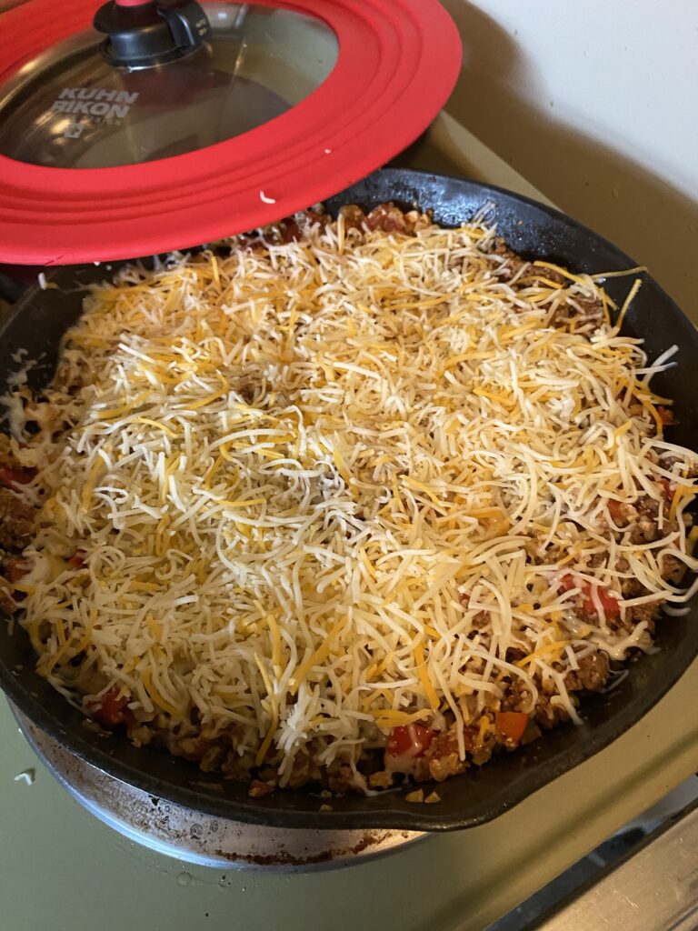 Top layer of cheese in cast iron  skillet