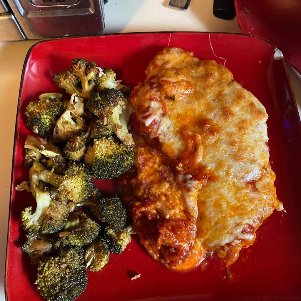 Simple keto Dinner on red plate with chicien and broccoli