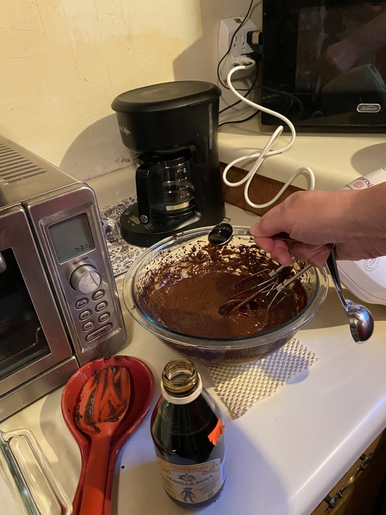 Pouring vanilla into brownie mix