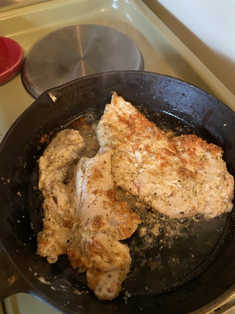 Chicken frying in pan