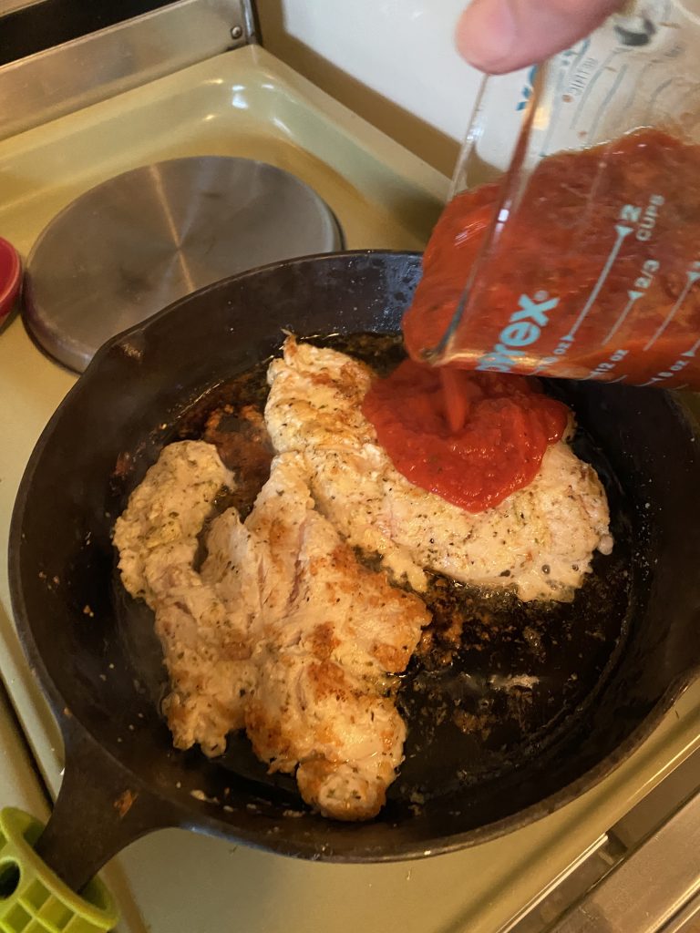 Pouring sauce over chicken