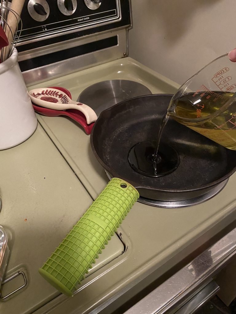 Olive oil heating in pan