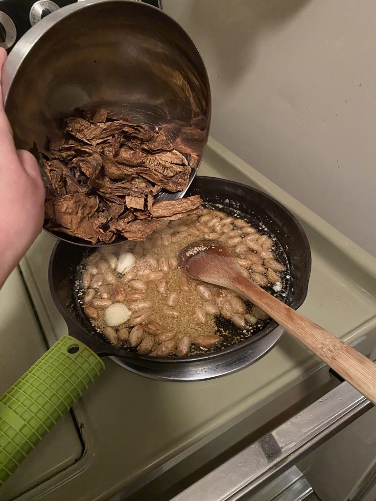 Adding chipotles into the pot