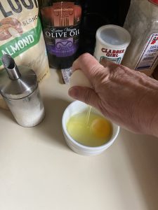 Egg dropping in bowl