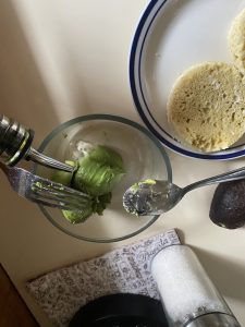 Pouring olive oil into mashed avocado