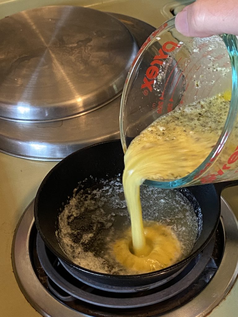 Pouring egg mixture into pan