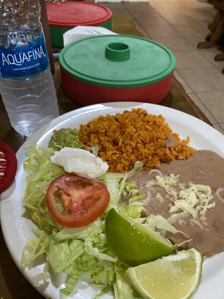 Plate of beans, rice, salad and limes