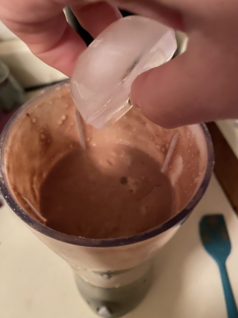 Adding ice cubes to the blender
