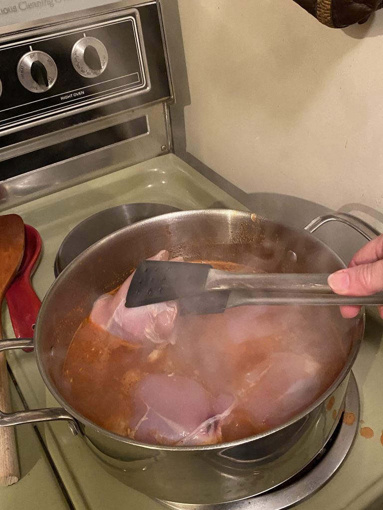 Adding chicken thighs to pot