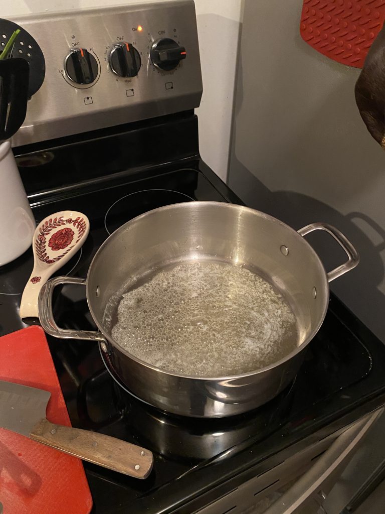 making soup by melting butter in pot