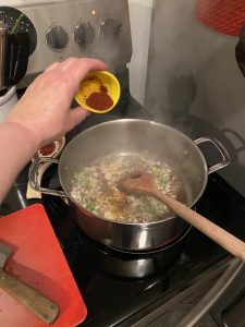 Adding paprika to soup