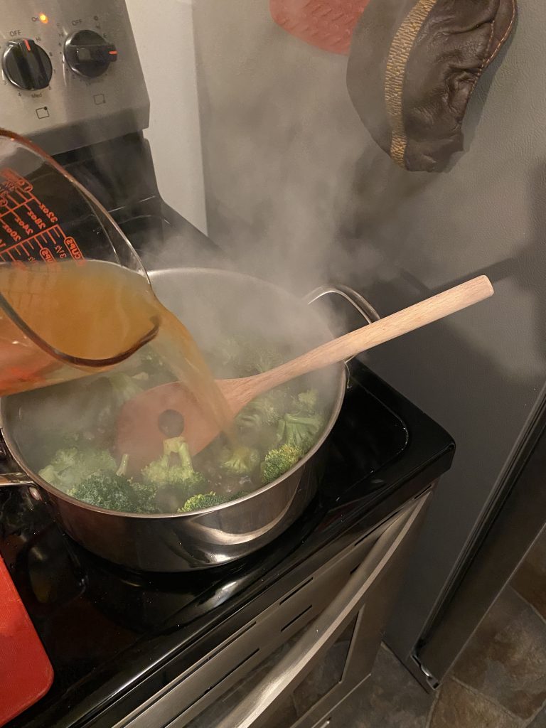 Adding stock to soup pot