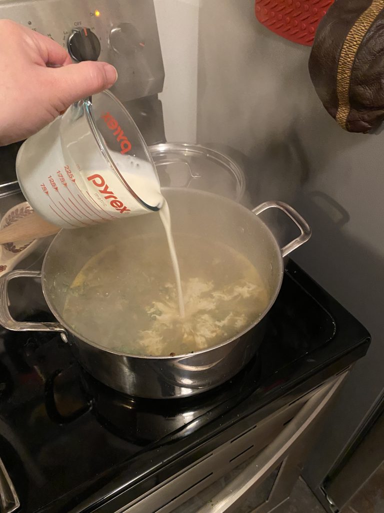 Adding cream to soup pot