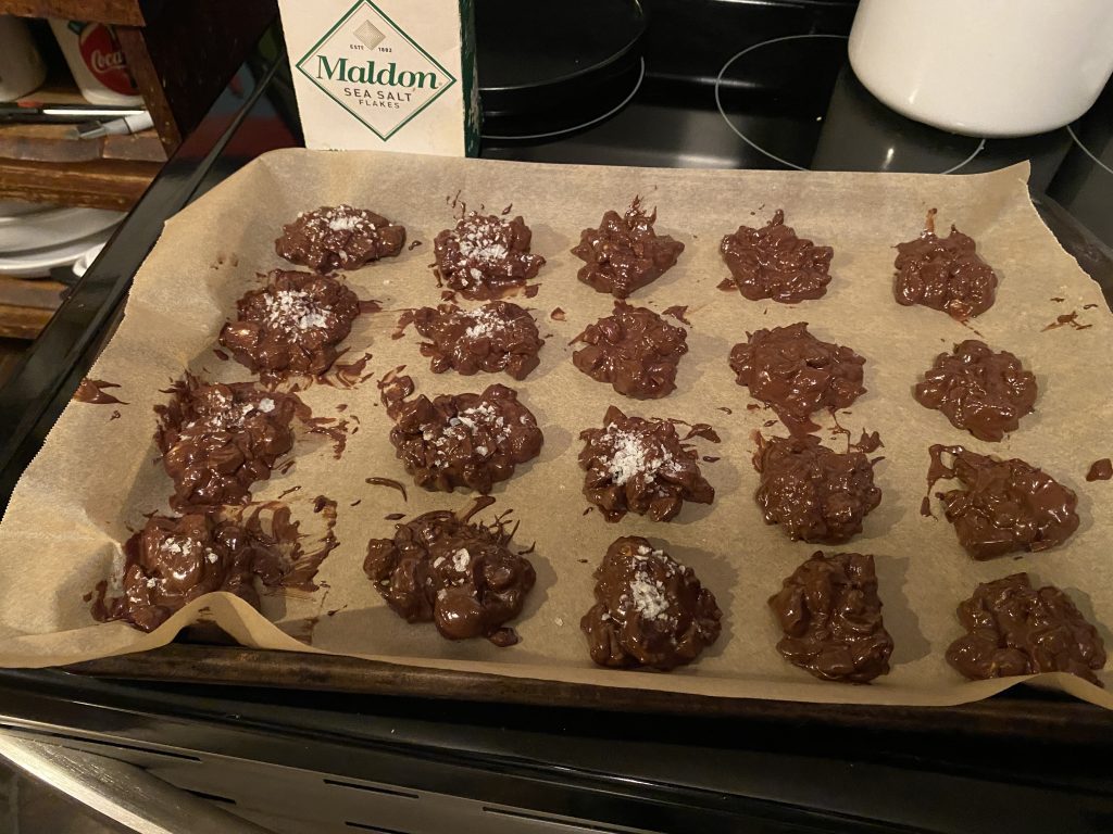Macadamia nut clusters on parchment paper with salt.