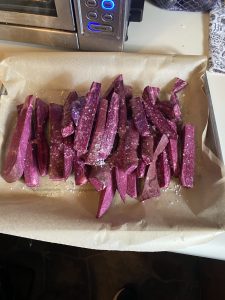 Cut purple sweet potatoes on baking sheet