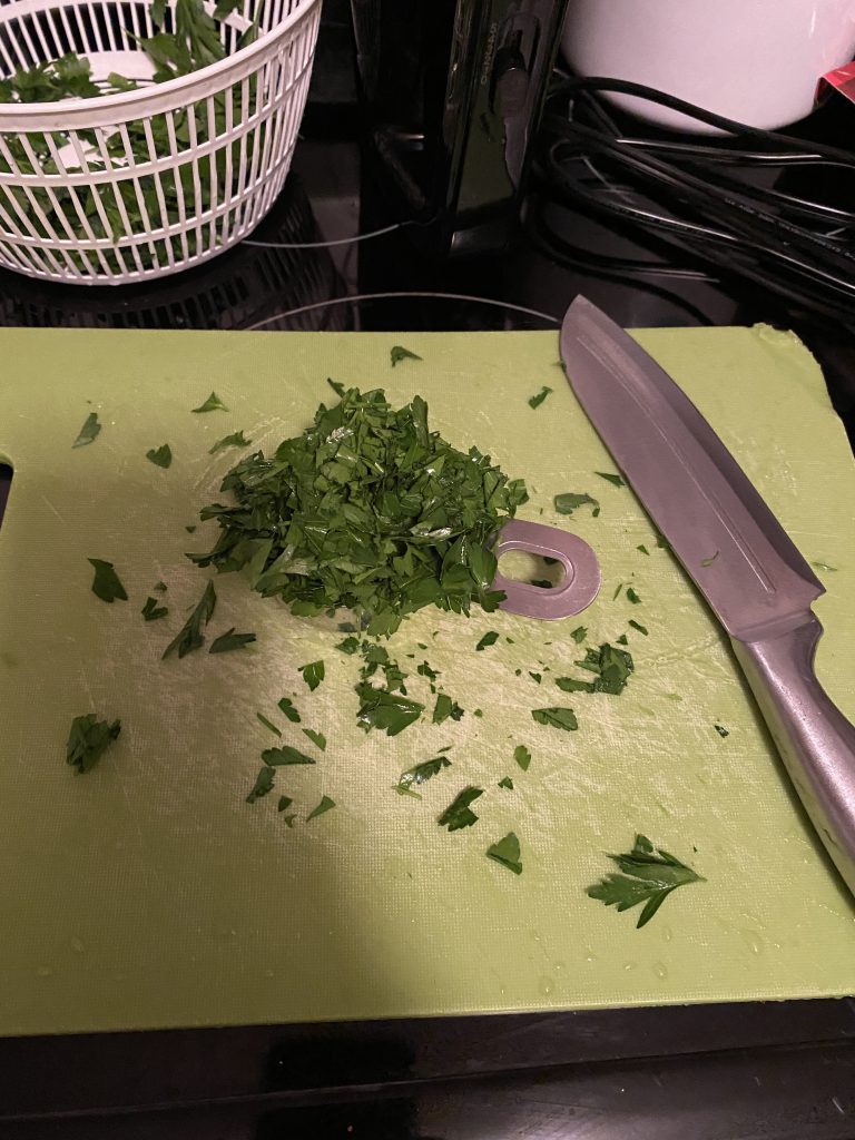 Chopping parsley on chopping board