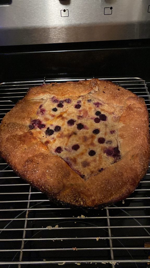 Baked blackberry galette on a baking rack