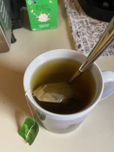 Cup of green tea brewing