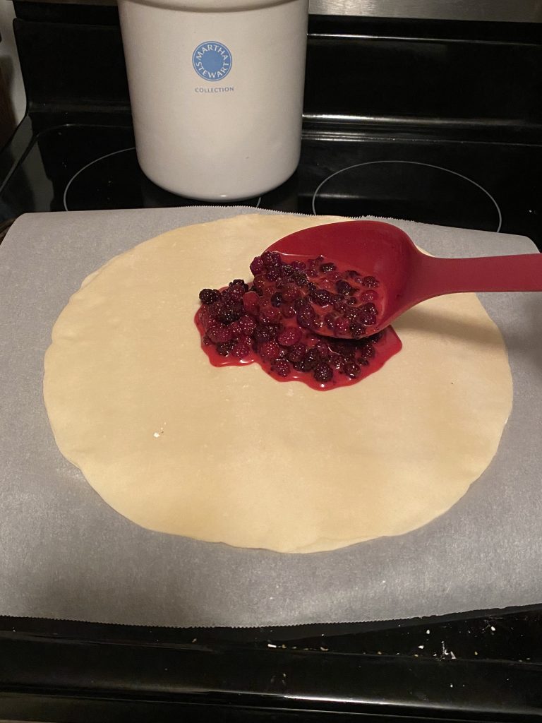 Adding blackberry mixture to pie crust