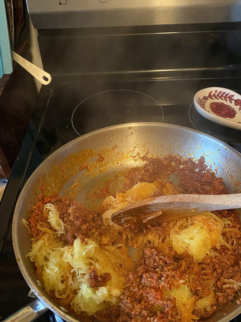Tossing spaghetti squash into mixture