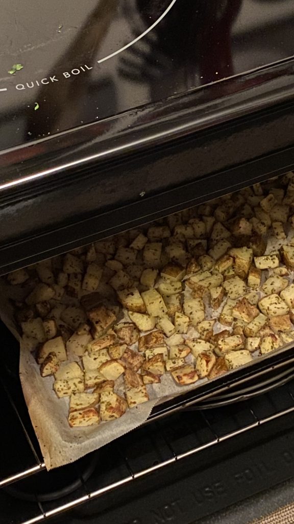 Cut potatoes on a sheet pan in an oven