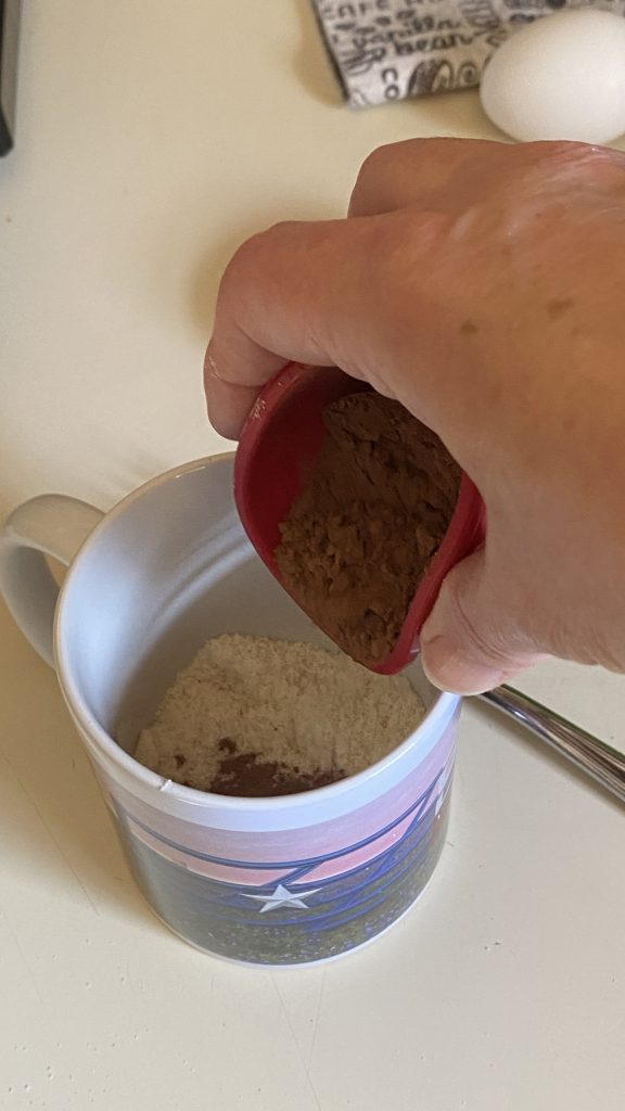 Adding cocoa powder into a cup