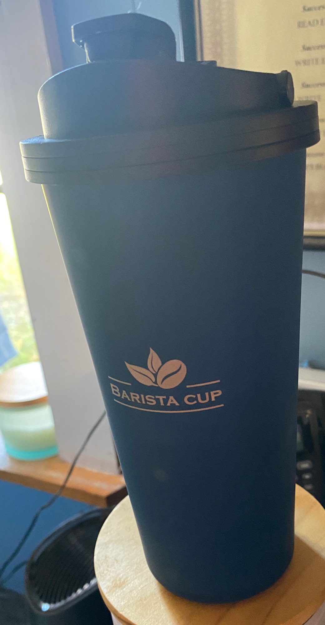 Picture of a Navy Barista Cup in the window